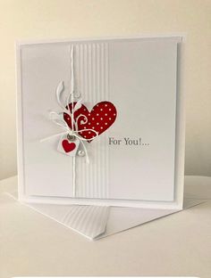 a white card with red hearts on it and the words for you written in black ink