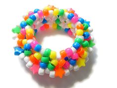 multicolored bracelets are arranged on a white surface