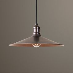 an industrial style pendant light hanging from a ceiling