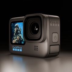 the gopro hero action camera is shown in front of a black background with an underwater scene