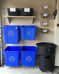 several plastic bins are lined up against the wall