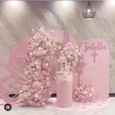 a pink altar decorated with flowers and a cross