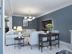 a living room with blue walls and white furniture