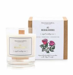 the berkshire scented candle in front of a box with its lid open and pink roses on it