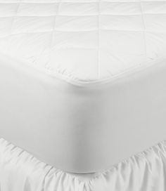 a white bed skirt with ruffles on the bottom and bottom edge is shown