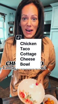 a woman holding up a sign that says chicken taco cottage cheese bowl with carrots