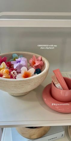 a bowl filled with flowers sitting on top of a counter