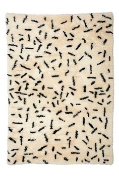 a white rug with black spots on it