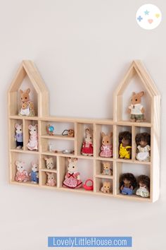 a wooden shelf filled with lots of stuffed animals on top of it's sides