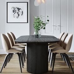 a dining room table with chairs around it and a vase filled with flowers on top