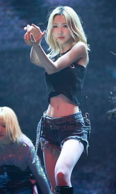 a woman in black shirt and shorts on stage