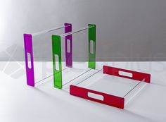 three different colored boxes sitting next to each other on top of a white countertop