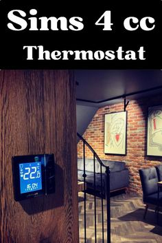 thermostaer is mounted on the wall next to stairs in a living room