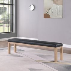 a wooden bench sitting on top of a carpeted floor in front of a window