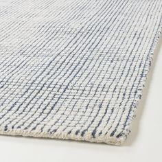 a blue and white rug on a white surface with lines drawn across the top of it