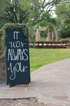 a chalkboard sign that says it was always you and has been placed on the sidewalk