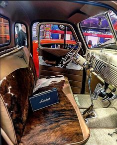 the interior of an old car with cow hide seats