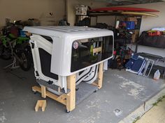 a garage with two motorcycles and a television in it