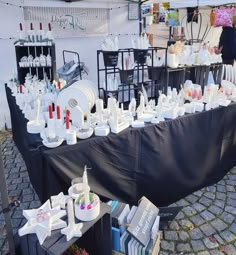 there are many bottles on the table and in front of it is a black tarp