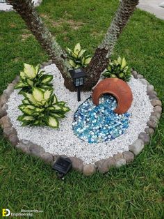 there is a small garden with rocks and plants in the center, along with two palm trees