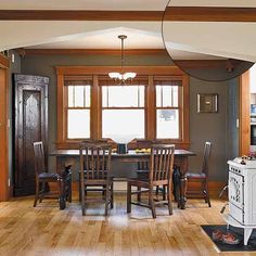 a dining room with wooden floors and gray walls