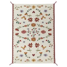 a white and red rug with flowers on it