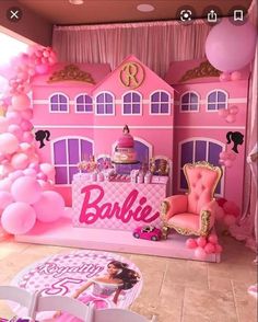 a pink barbie birthday party with balloons and furniture