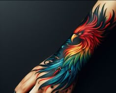 a hand with a colorful bird tattoo on it