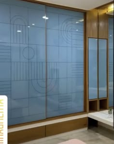 a bathroom with blue glass doors and a bathtub in front of the shower area