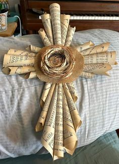 a cross made out of old sheet music paper