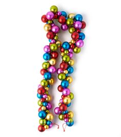 the letter j is made up of multicolored balls and streamers on a white background