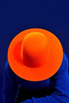 a person wearing a bright orange hat