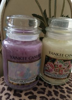 two yankee candles sitting next to each other