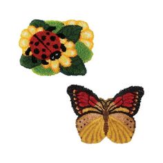 two embroidered patches, one with a ladybug and the other with a flower