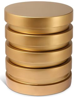 a stack of gold plates sitting on top of each other