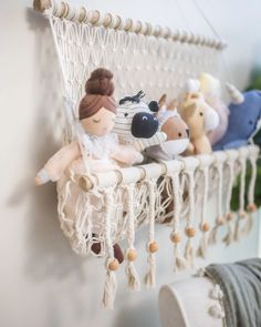 several stuffed animals are hanging from a macrame