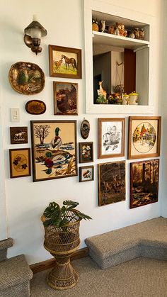 there are many framed pictures on the wall