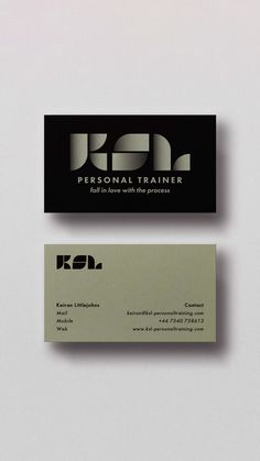 two business cards sitting side by side on top of a white surface with black lettering