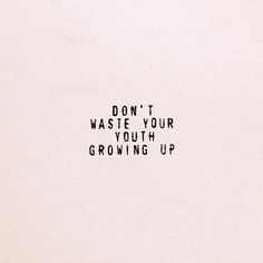 the words don't waste your youth growing up are written in black on a white paper