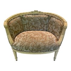 an old fashioned chair with floral designs on it's back and seat cushion, sitting in front of a white background