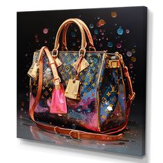 a colorful handbag with gold hardware and pink tassels on the handles is displayed