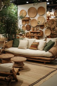 a living room filled with lots of wicker furniture next to a wall covered in plants