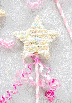 a star shaped cake on top of a pink and white lollipop stick with sprinkles