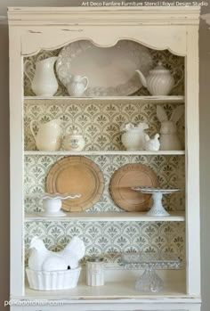 an old china cabinet with plates and dishes on it