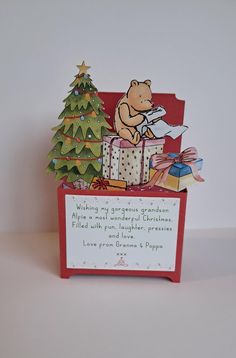 a winnie the pooh christmas card in a red box with a tree on it