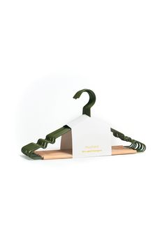 a green and white wooden hanger with an arrow on it's end, against a white background