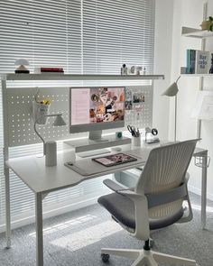 a white desk with a computer on it