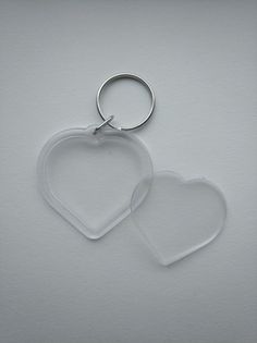 two clear heart shaped key chains on a white background with space for your own text