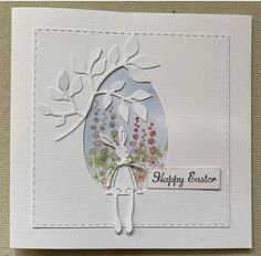 a white card with an image of a person holding a tree and the words happy easter on it