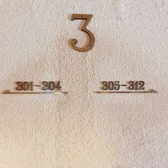 the number three is in front of two numbered numbers on a white towel with gold trim